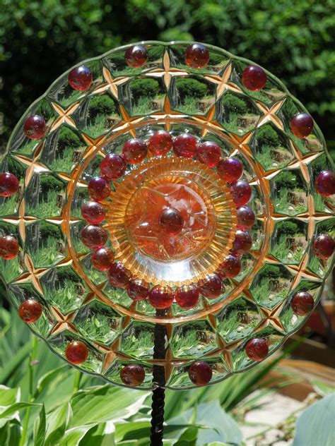 Each uinque piece made with repurposed glassware the above glass flower created with an. GARDEN stakes and YARD sun catcher made with recycled ...