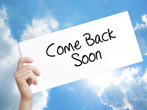 Come Back Soon Sign On White Paper Man Hand Holding Paper