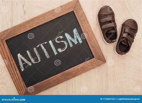 Top View Of Autism Lettering Written On Chalkboard Near Children Brown