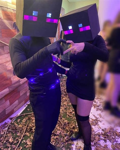 Two People Dressed Up As Minecrafts In Costume And Holding Controllers