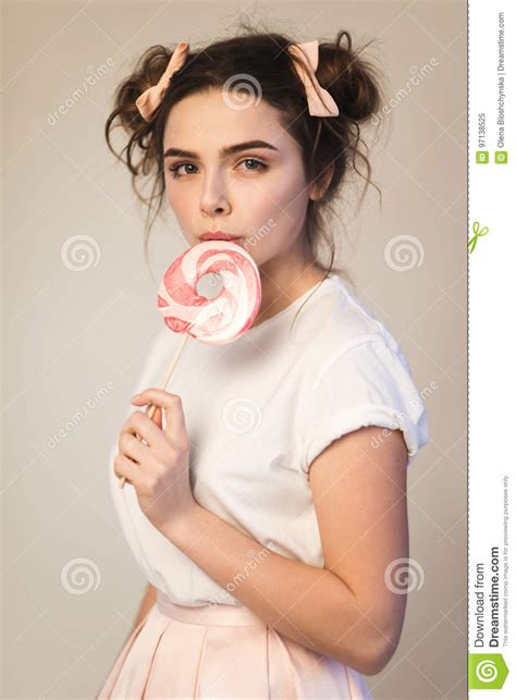 beautiful brunette girl with candy in her hands stock image image of holiday adult 97138525