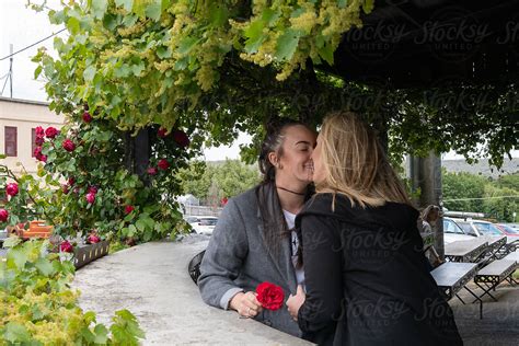 Lesbian Couple Share A Valentines Kiss Del Colaborador De Stocksy