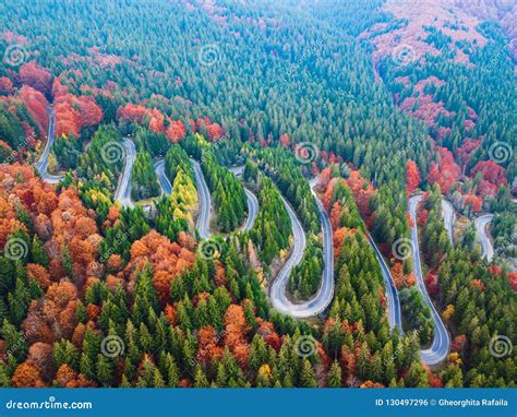 Winding Road From High Mountain Pass In Autumn Season With Orange