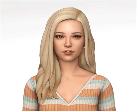 A Woman With Long Blonde Hair Wearing A Striped Shirt And Earrings Is