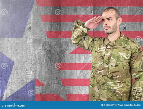 Proud Soldier Saluting Against American Flag Background Stock Image