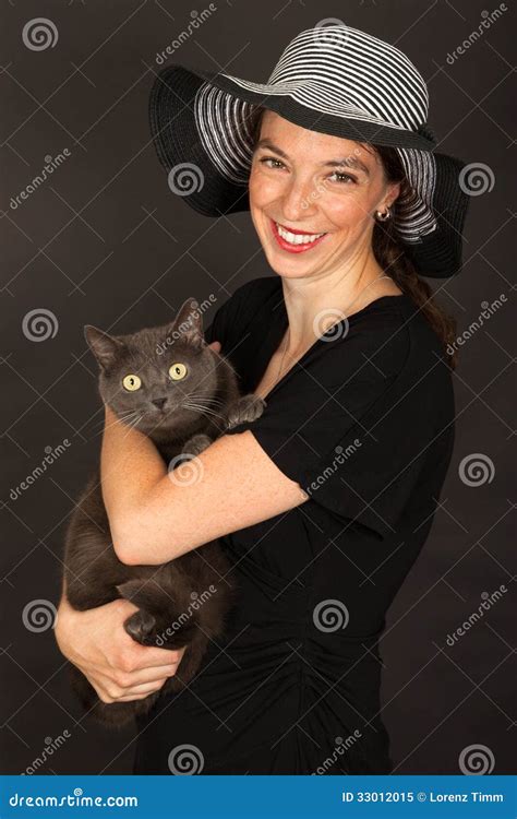The Woman Is Holding The Cat In Her Arms Stock Image Image Of Mammal