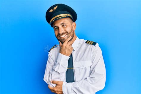Handsome Man With Beard Wearing Airplane Pilot Uniform Looking