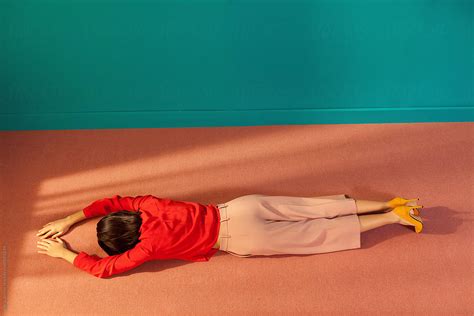 woman lying face down on the floor of a room by stocksy contributor ulasandmerve stocksy