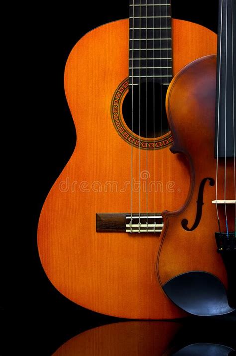 Vintage Violin And Wooden Guitar On Dark Background Stock