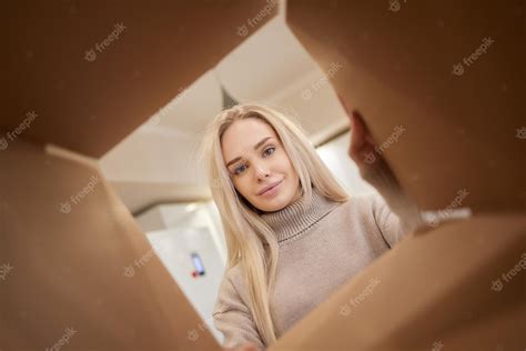 Premium Photo Woman Looking Down At Camera Through Cardboard Box