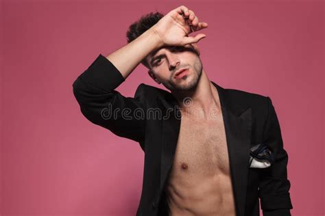 Sensual Man With Naked Chest Puts His Hand On Forehead Stock Photo