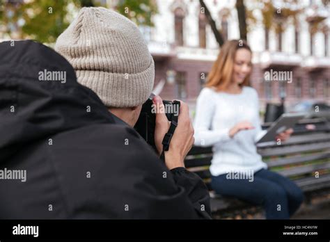 Back View Of Man Photographer Taking Pictures Of Happy Lovely Young