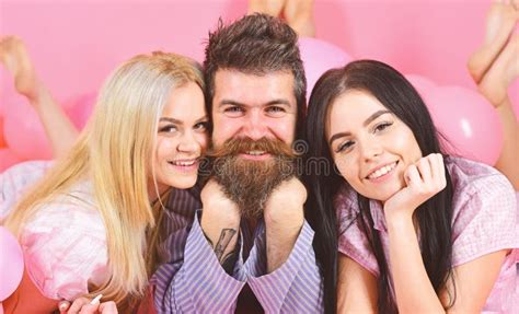 Girls Fall In Love With Bearded Macho Pink Background Threesome On Smiling Faces Lay Near