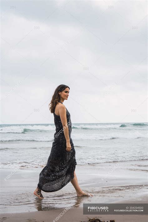 Elegant Woman In Black Dress Walking On Beach — Seaside Outdoors