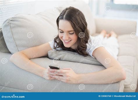 Smiling Cute Woman Lying On A Cosy Couch Sending Text Message Stock Photo Image Of House