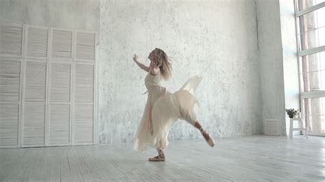 A Young Ballerina Is Dancing In A White Light Dress Ballet Dancer In