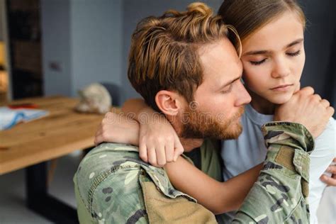 Masculine Sad Military Man Hugging Her Daughter Indoors Stock Photo