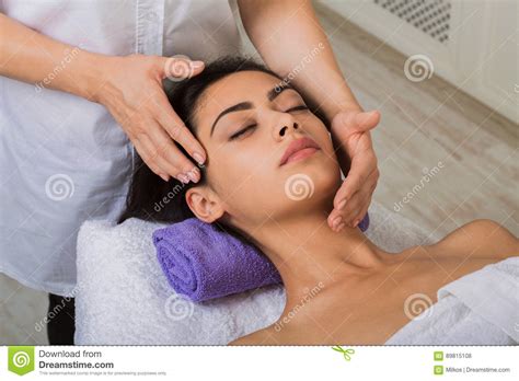 Woman Massagist Make Face Lifting Massage In Spa Wellness Center Stock