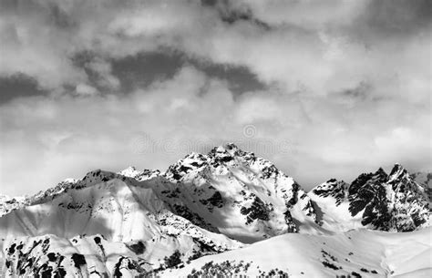 Black And White Snow Slope And Winter Sunlight Mountains In Clouds