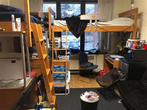 A Room With Bunk Beds Desks And Other Items In It On The Floor