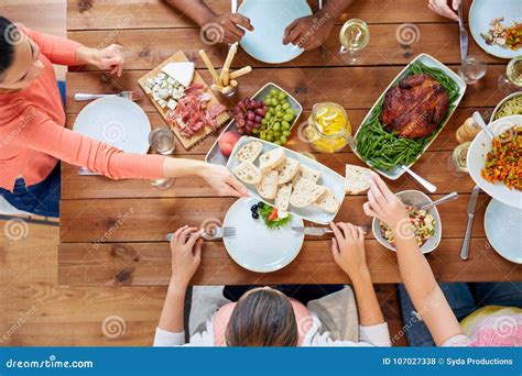 Group Of People Eating At Table With Food Stock Photo Image Of Dish