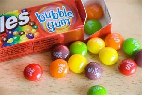 A Box Of Gum And Some Candy Balls On A Table