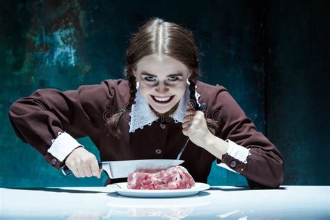 Bloody Halloween Theme Crazy Girl With A Knife Fork And Meat Stock