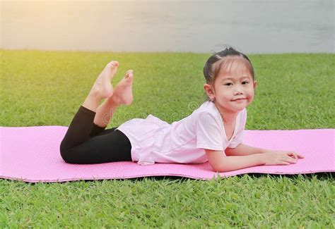 Portrait Of Little Asian Child Girl Doing Yoga In The Public Park