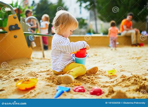 Adorable Little Girl On Playground In Sandpit Stock Photo Image Of