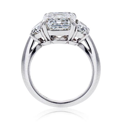 Featuring two tapered baguette diamonds precisely cut to frame a classic round brilliant centre stone, this tiffany three stone diamond engagement ring is a study in timeless beauty and extreme attention to detail. Tiffany and Co. 3.33 carat Emerald Cut Three-Stone Diamond Engagement Ring For Sale at 1stDibs