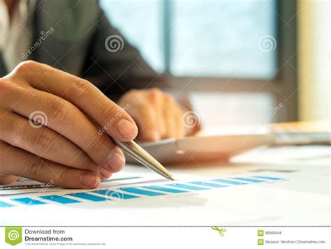Businessmen Analyzing Graphs And Using Calculator. Stock Photo - Image ...