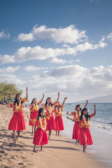 Group Of Traditional Hawaiian Hula Dancers Performing On The Beach In