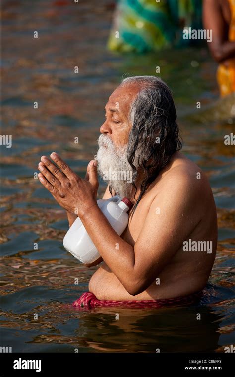 indian hindu pilgrim bathing and praying in the ganges river at dashashwamedh ghat in holy city