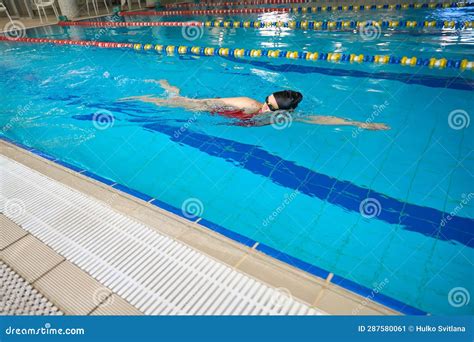 Professional Swimmer Practicing Freestyle Stroke In Swimming Pool Stock