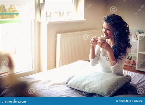 Beautiful Young Woman Drinking Morning Coffee In Bed A Stock Image