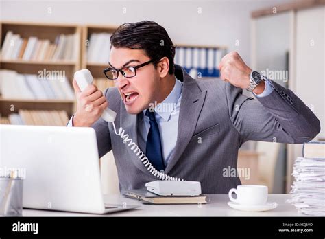 Angry Businessman With Too Much Work In Office Stock Photo Royalty