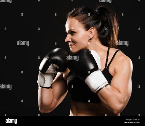 female fighter ready to fight beautiful muscular fitness woman wearing boxing gloves stock