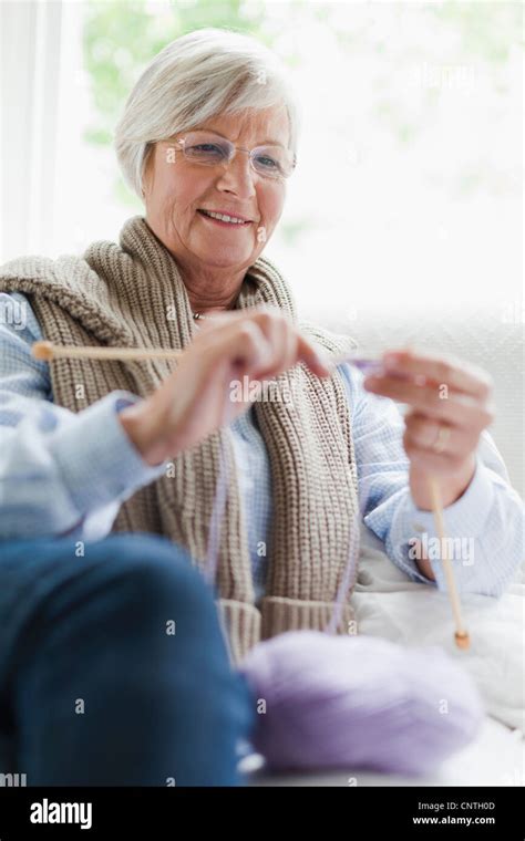 Smiling Older Woman Knitting Stock Photo Alamy