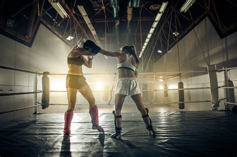 Two Tough Women Fighting On A Boxing Match In Health Club Stock Photo