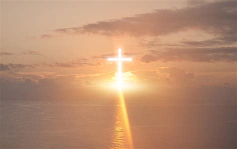 Bright Cross Lit Up In A Sunset Sky Over Water Stockfreedom Premium