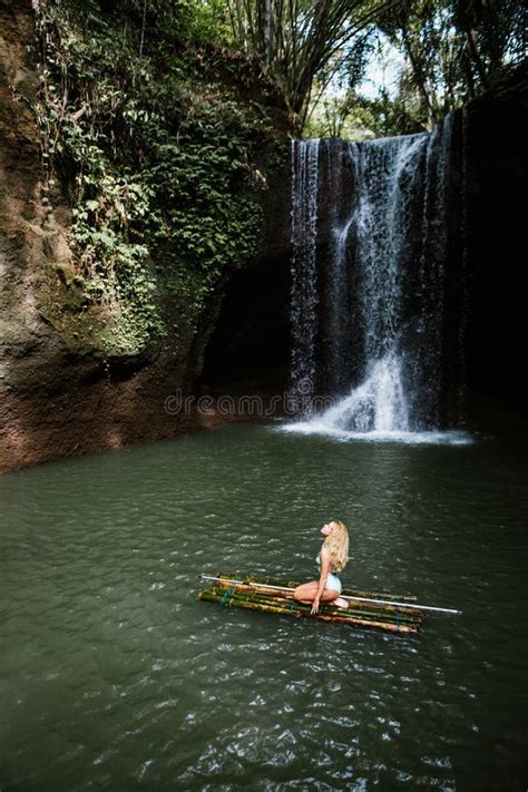 Woman Have Fun In Natural Pool Under Tropical Waterfall Stock Photo