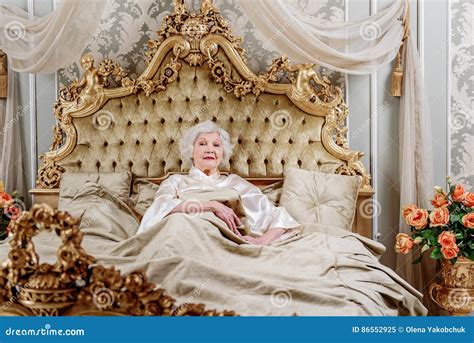 Confident Old Woman Lying On Expensive Bed Stock Image Image Of