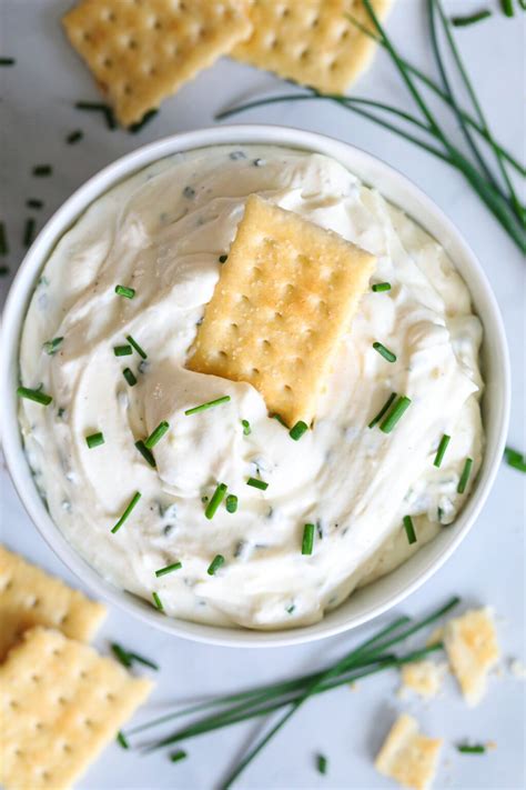 Aerial View Of Garlic Cream Cheese Dip With A Cracker In It And More On