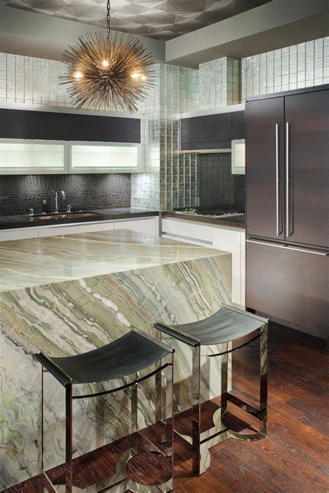 Designer and exclusive pieces, created for a contemporary london apartment, chromed glass orbs in a mix of varying sizes, adds to the simplicity and minimal design of the cooking and diner area. Sleek Art Deco Kitchen With Stunning Stone Island | HGTV