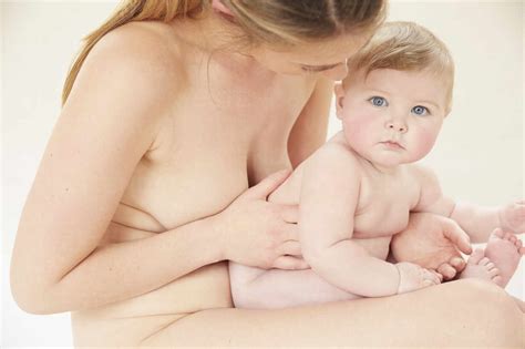 Naked Mother Bonding With Naked Baby On Lap Stock Photo