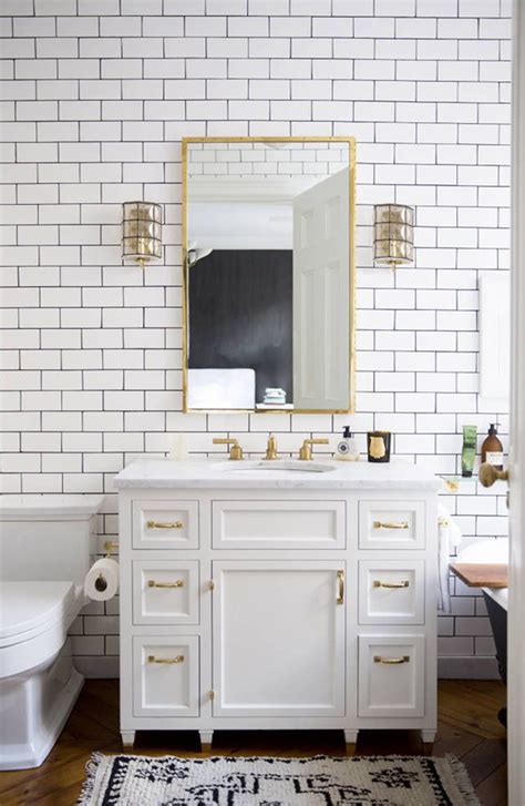 This contemporary bathroom is colorful and bright with it's brass fixtures, white penny tile backsplash, and blue grout. Dreaming of a Bathroom Renovation | Ciera Design Studio
