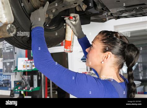 Car Mechanics Repairing A Car On Hydraulic Lift Stock Photo Alamy