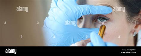 Doctor Shines Light Into Patient Eye To Check Pupil Closeup Stock Photo