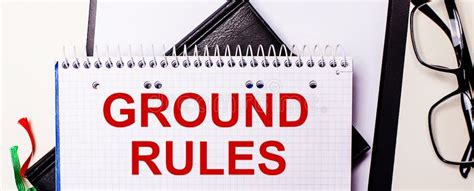 The Words Ground Rules Is Written In Red In A White Notebook Next To