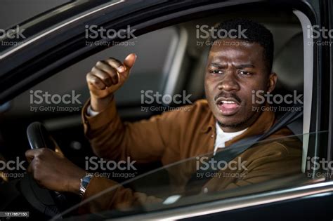Angry African American Man Driving A Car And Arguing With People In